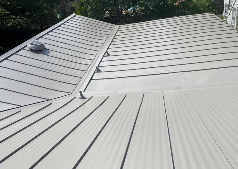 Solar attic fan installed on a metal roof for Roof Ventilation in Harris